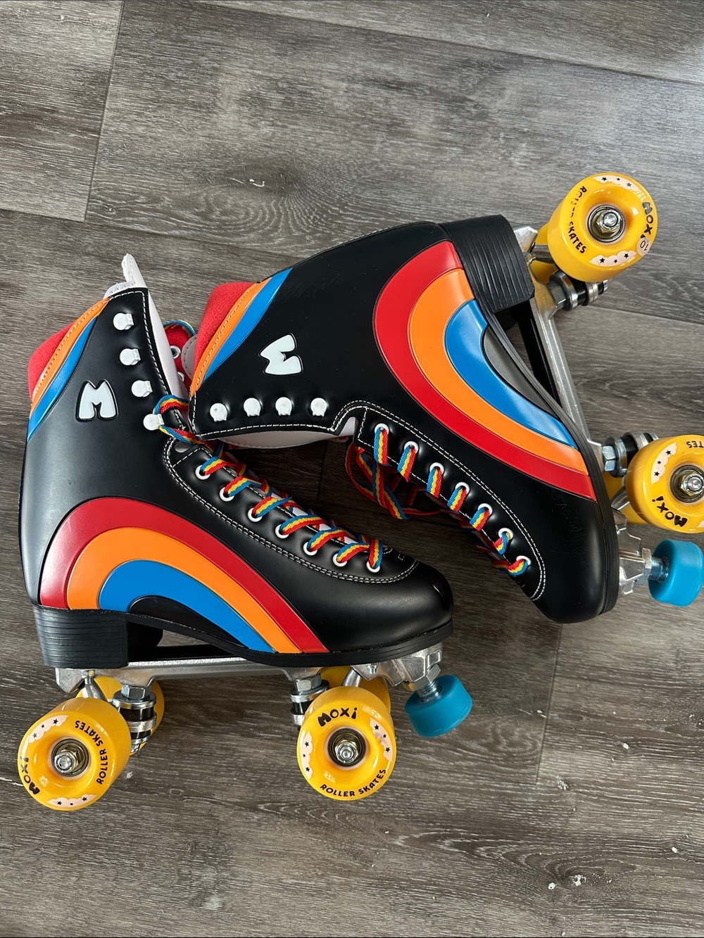 Moxi Black Retro Rainbow Roller Skates with Yellow Wheels